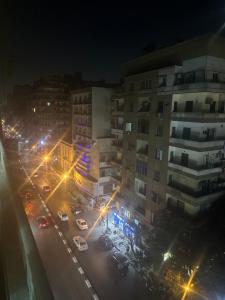 una calle de la ciudad por la noche con edificios y luces de la calle en Beautiful apartment in the heart of cairo, en El Cairo