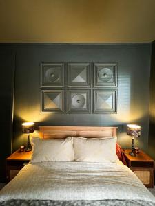 a bedroom with a large bed with two lamps on tables at La Chambre des Trois Églises in Riquewihr