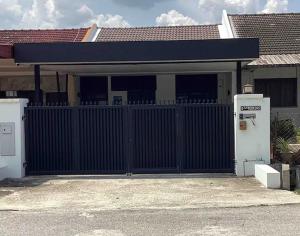 a garage with a black gate in front of a house at IPOH 8Perkins Canning Garden 7-8pax Elegant Homestay with 4Bedrooms, 3Bathroom, 1Living, 1Dining, 1Kitchen-Bar with 3Parkings in Ipoh