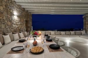 a dining room with a table and a bath tub at Villa HADI, ideal for large groups and families in Kalo Livadi