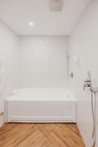 a white bathroom with a tub and a shower at SPA Hotel Green Park in Garmen