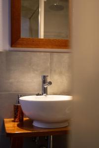 a white sink in a bathroom with a mirror at Pokoje Gościnne Karolina in Poronin