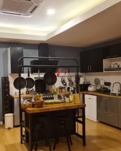 a kitchen with a table with pots and pans at บ้านสวนภาคินรัตน์ 