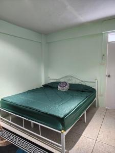 a bed in a room with a green mattress at 812 Quiet and Cozy Apartment in Bangkok