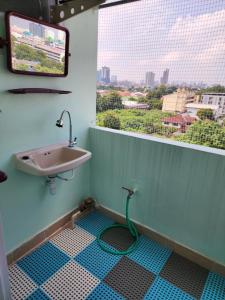a bathroom with a sink and a window at 812 Quiet and Cozy Apartment in Bangkok