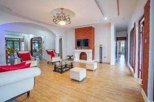 a living room with a fireplace and a tv at Sprunger Avenue - tulia homes in Moshi