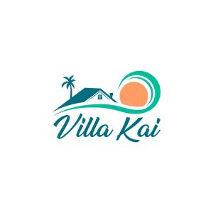 a villa with a palm tree and a house on the beach at Villa Kai in Trou d'Eau Douce