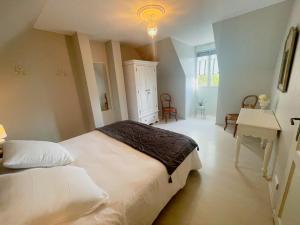 a bedroom with a bed and a desk and a sink at maison philirina in Athée-sur-Cher +27 photos