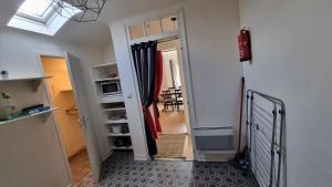 a hallway with a stairway leading to a room with a window at Appartement T2 COSY HENDAYE CANETA in Hendaye