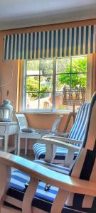 a room with two chairs and a table and windows at Casa Andrea in Valdoviño