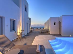 a villa with a swimming pool with a view of the ocean at Hotel Papadakis in Naousa