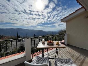 a balcony with a table with a cake on it at Chalet Arachova - Breathtaking View in Arachova