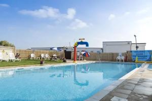 a large swimming pool with a water slide at Beautiful 2-Bed Holiday home in Whitstable