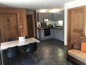 a kitchen with a table and chairs and a couch at Chalet Hestia in Champéry