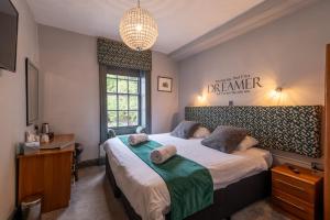 a bedroom with two beds and a window at Crown and Cushion Appleby in Appleby