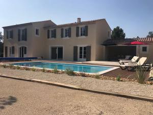 a house with a swimming pool in front of it at Imola - Côté Ventoux in Bédoin
