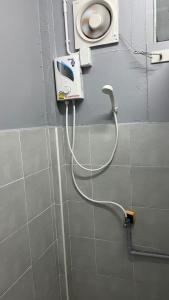 a bathroom with a hair dryer on the wall at W District hostel in Bangkok