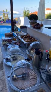 a buffet with plates of food on a table at Abbey Resort in Monastiraki