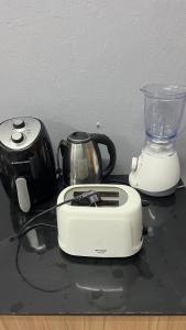 a toaster and a blender sitting on a table at W District hostel in Bangkok