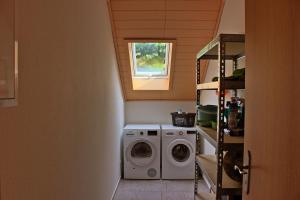 a laundry room with a washing machine and a window at Ferienwohnung Preisinger in Gammertingen