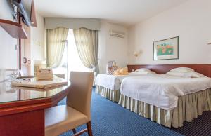 Postel nebo postele na pokoji v ubytování Hotel Garden Terme + 37 fotografií