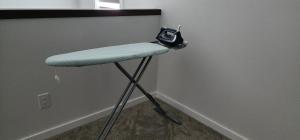 a stool with a purse sitting on top of it at Chesskings Suites - Polo-Park - 2 Bedrooms - Executive in Winnipeg