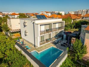 an aerial view of a house with a swimming pool at Apartmani Diva in Zadar