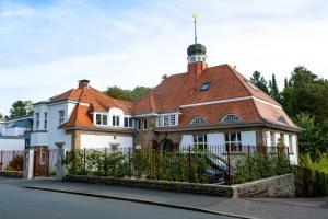 a large white house with a red roof at DESIGN-Studio CHURCH 46 in Mülheim an der Ruhr