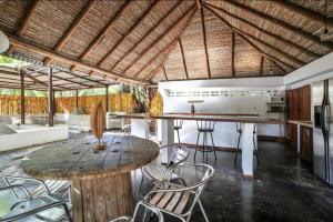 a kitchen with a table and chairs in a room at Pipe House Luxury Beach Glamping Retreat in Barco Quebrado