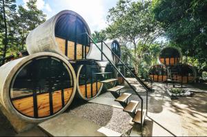 a set of spiral stairs in a park at Pipe House Luxury Beach Glamping Retreat in Barco Quebrado