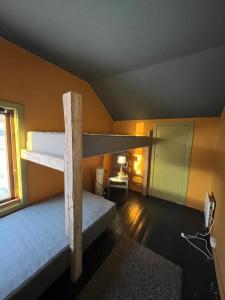 a room with two bunk beds and a window at Storjord Farmstay Ranchhouse in Kvaløya