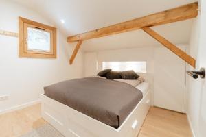 a bedroom with a bed in a white room at Vois le Mont in Les Gets