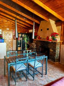 a dining room with a table and chairs and a fireplace at El Paraje del Chef in Laroles