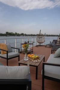 a table with a bowl of fruit on the deck of a boat at Splav Nala in Belgrade