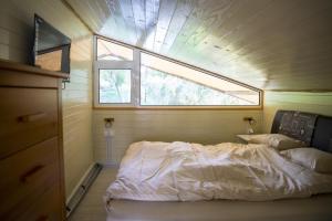 a small bedroom with a bed and a window at Splav Nala in Belgrade +18 photos