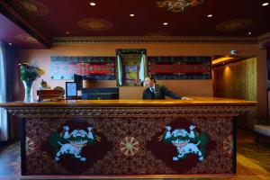 a man sitting at a bar in a restaurant at Gakhil Boutique Hotel in Darjeeling