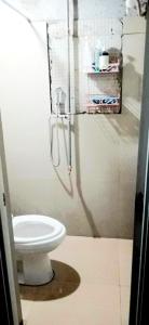 a bathroom with a toilet and a shower stall at Eastdee Homestay By Jaya in Lidlidda