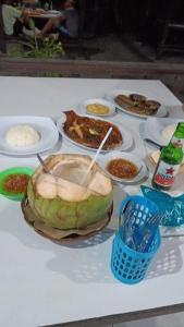 a table with a plate of food on it at Lavanda guesthouse/homestay in Jimbaran