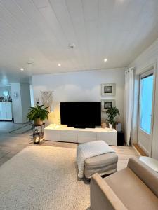 a living room with a large flat screen tv at Villa Aurora View in Rovaniemi