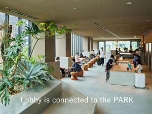 a lobby with people sitting at tables in a park at sequence MIYASHITA PARK - Shibuya in Tokyo