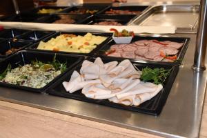 a buffet line with many different types of food at UNI Hostel in Maribor