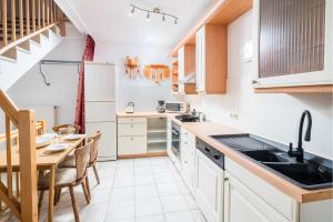 a kitchen with white cabinets and a table and a dining room at Unterkunft DHH mit 5 Zim in Schmatzhausen