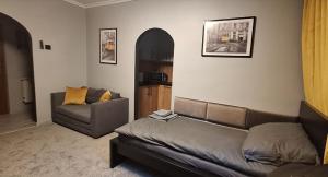 a living room with a couch and a chair at Medyka Loft in Medyka