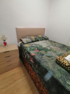 a bedroom with a bed and a night stand at ROOMS Beach 5 MIN Playa in Alicante