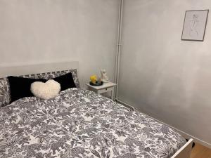 a bedroom with a bed with a heart pillow on it at 2 Superbes chambres d hôte dans un appartement avec magnifique vue sur Paris in Sucy-en-Brie