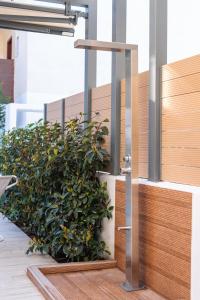 a plant in a planter on the side of a building at Domenica Diamond Villas - Heated Pool & 80m from the Beach in Hanioti