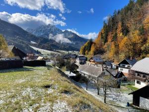 a village in a valley with mountains in the background at Apartma Devs in Kranjska Gora