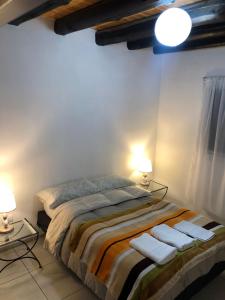 a bedroom with a bed with two lamps and towels at AeroSuites in Las Heras