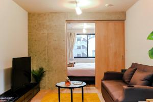 a living room with a couch and a bed at Seirai Asakusa Vacation Rental - 3 minutes from station in Tokyo