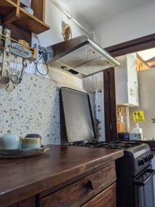 a kitchen with a counter with a stove top oven at Thee&Thou Cottage in Breaza